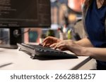 System administrator at office coding on her computer creating a software and works on implementing algorithms. IT expert building applications with a programming interface. Close up.