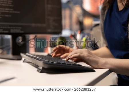 System administrator at office coding on her computer creating a software and works on implementing algorithms. IT expert building applications with a programming interface. Close up.