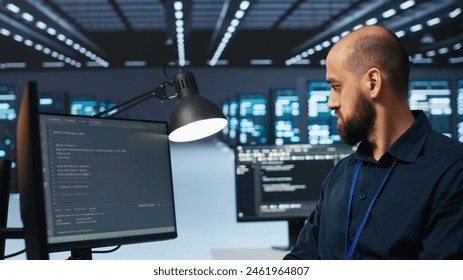 System administrator in server hub coding, ensuring data remains shielded from threats. IT developer safeguarding supercomputers against unauthorized access, securing system from hackers