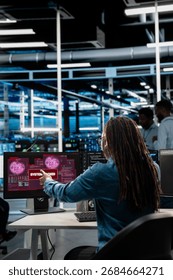 System administrator in server hub trying to protect hardware from hacker attack stealing sensitive information. Data center cybersecurity specialist fighting virus during security breach