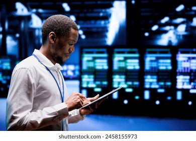 System administrator in server hub using renewable hydro energy sources to power cryptocurrency mining operations. Manager inspecting eco friendly supercomputers preventing environmental impact - Powered by Shutterstock