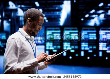 System administrator in server hub using renewable hydro energy sources to power cryptocurrency mining operations. Manager inspecting eco friendly supercomputers preventing environmental impact