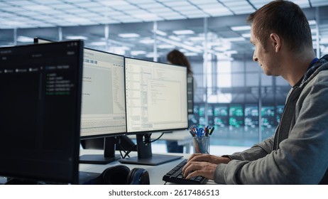 System administrator in server room doing system analysis, coding supercomputers. Specialist working in high tech facility housing advanced storage infrastructure, camera B close up