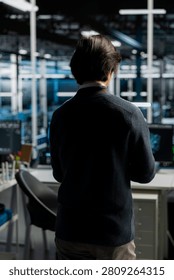 System administrator uses a computer in a data center to deploy software updates, configure hardware, and support reliable operations.