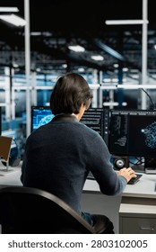 System administrator uses a digital device in a data center to support automation monitoring and reliable server workflows.