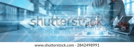 System administrator using a tablet to analyze settings data configuration parameters, customization security optimization automation integration transformation performance management.