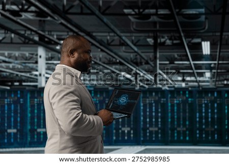 System administrator working in data center providing computing resources to enable AI training and inference. Server hub worker using machine learning tech to optimize operations and efficiency