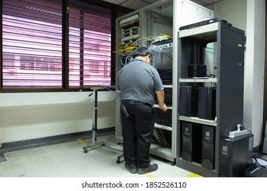 The system administrator works in the server room of the data center.	 - Shutterstock ID 1852526110