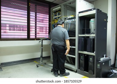 The system administrator works in the server room of the data center.	 - Shutterstock ID 1857105529