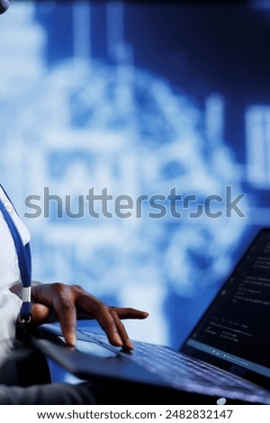 System administrator writes code on laptop to visualize artificial intelligence neural networks using augmented reality, close up. High tech facility worker runs AI script for information processing