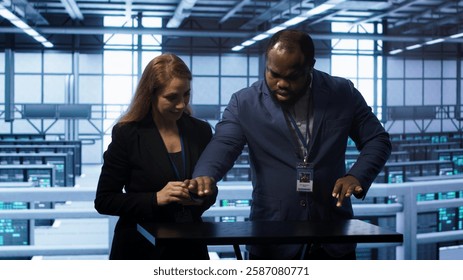 System administrators looking at holograms in data center, doing swiping motions hand gestures. Server farm workplace employees interacting with augmented reality tech, camera A