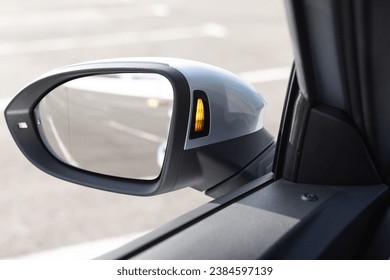 System blind spots of the car. Detail of side keeping assist system switch button. Blind zone monitoring sensor on the side mirror of a modern electric car.