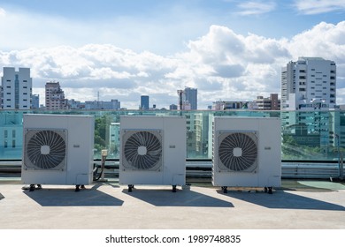 System of central compressor machine part of air conditioner system set on the roof or building deck with sky background.