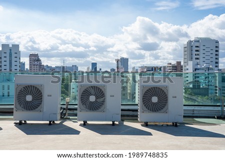 System of central compressor machine part of air conditioner system set on the roof or building deck with sky background.