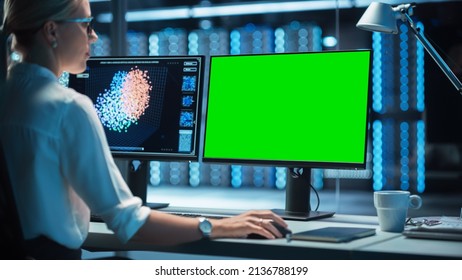 In the System Control Data Center Operates Multiple Screens with Neural Network and Data Activities. Room is Dark and Full of Monitors with Working Neural Network on Them.