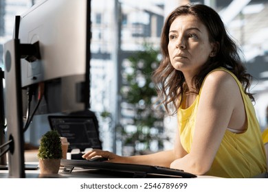 System engineer fixing applications issues, dealing with databases and server configuration. IT professional using computer, optimizing company software for improved performance and scalability