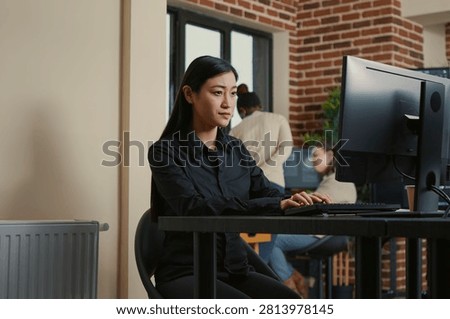 System Engineer Smiling After Successful Code Compile at a software development desk after compiling source code successfully, showing algorithm work and coding success.