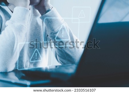 System hacked alert after cyberattack on computer network Compromised information concept. Internet virus, cybersecurity and cybercrime. A desperate, sad woman sitting in front of his infected compute