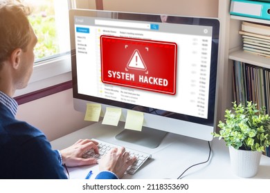 System hacked alert on computer screen after cyber attack on network. Cybersecurity vulnerability on internet, virus, data breach, malicious connection. Employee working in office. - Shutterstock ID 2118353690