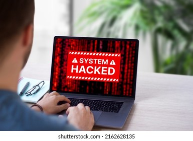 System hacked red alert on computer laptop screen. Warning message of hacking attack by malware, virus or spyware after malicious online connection. Cybersecurity and vulnerability concept. - Shutterstock ID 2162628135