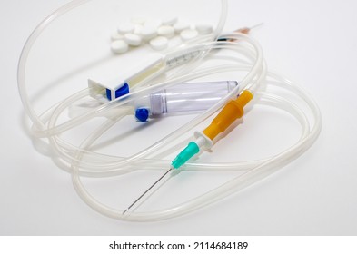 A System For Intravenous Drug Administration, A Syringe And Pills On A White Background.