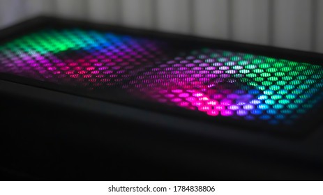 System unit, computer with RGB backlit light cooler. Neon multicolored light in the dark.