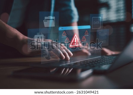 System warning alert with AI and data error concept. Man working on laptop with futuristic interface showing critical error signs, system failure, data breach, and cyber risk notifications.