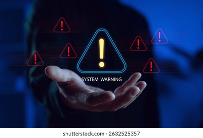 System warning alert concept with a hand holding a glowing warning icon, symbolizing cybersecurity risks, data errors, malware threats, and digital system failures in a tech environment.