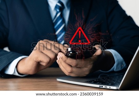 System warning hacked alert, cyber attack on computer network.Businessman using mobile phone with warning sign notification error, Malicious software,virus and cybercrime, Cybersecurity,data breach.