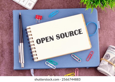 System and website builder concept. OPEN SOURCE in the notebook, top view. Copy space.