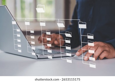 Systematic data storage for ease of use. Folder hierarchy structure and document management system DMS. Businessman using laptop computer for saving and classifying files.