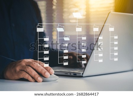 Systematic data storage, Folder hierarchy structure, Document management system DMS, Saving and classifying files, Digital file, Storage secure, Businessman selecting files on cloud and using laptop