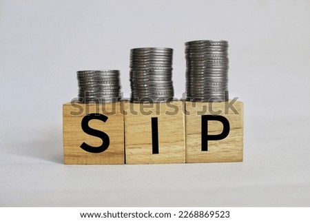 Systematic investment plan (SIP) concept on wooden blocks.