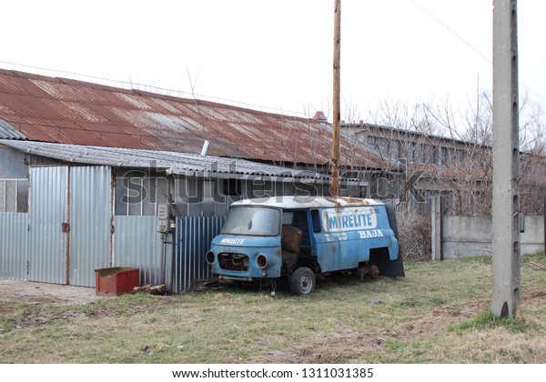 Szabolcs/HUngary - circa 2017: Abandoned truck\
at yard with industrial\
buildings