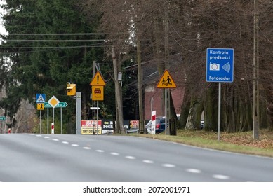 Szadki, Poland - November 5, 2021: Speed camera at the pedestrian crossing in front of the intersection. Information signs about speed measurement in built-up areas. Safety on the road.