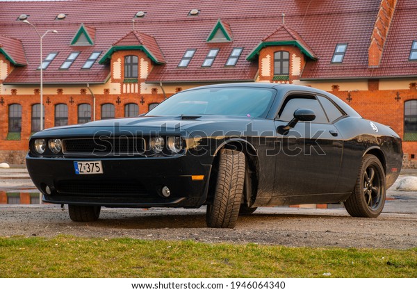 Szczecin, Poland-March 2021: Dodge Challenger -\
a classic American muscle car against the backdrop of the city\
space of the port city of\
Szczecin