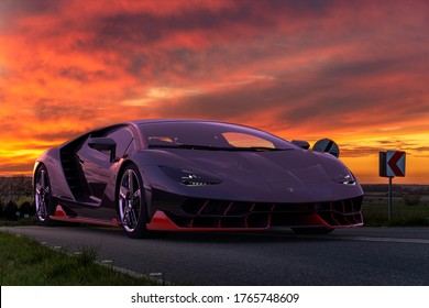 Szczecin,Poland-April 2020:Lamborghini supercar driving down the road during a dramatic sunset	
