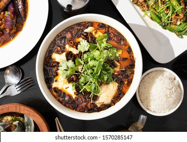 Szechuan food in a restaurant. Spicy Sichuan fish soup made with pungent chili peppers and fresh cod. Authentic and fiery Chinese food. - Shutterstock ID 1570285147