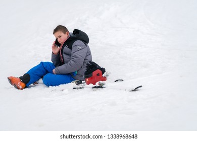 Szklarska Poreba, Poland - February 2019 : Young Boy Calling For Help On His Mobile Phone After Skiing Or Snowboarding Accident On The Mountain Slope, Szrenica Mountain, Karkonosze