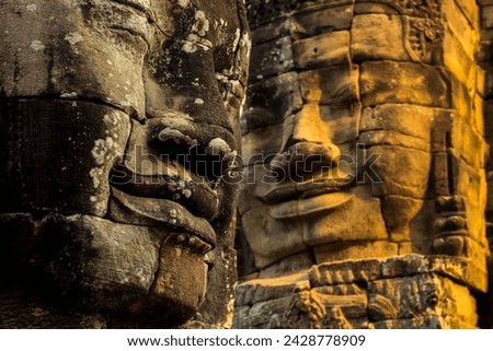 T wo of 216 smiling sandstone faces at 12th century bayon, king jayavarman vii's last temple in angkor thom, angkor, unesco world heritage site, siem reap, cambodia, indochina, southeast asia, asia