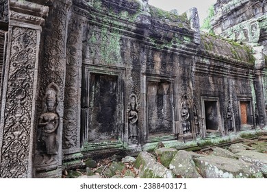 Ta Phrom - Iconic 12th century Angkor Khmer Temple with Tree roots intertwined with the temple structure, famous for Tomb Raider movie featuring Angelina Jolie at Siem Reap, Cambodia, Asia