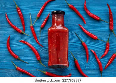 Tabasco hot pepper sauce with red chili pepper, flat lay. - Powered by Shutterstock