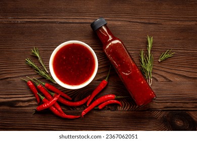 Tabasco hot pepper sauce with red chili pepper, flat lay