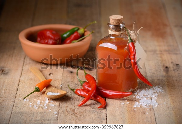 tabasco sauce in
the bottle with chili
around