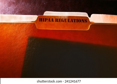 tabbed file folders with HIPAA Regulations text