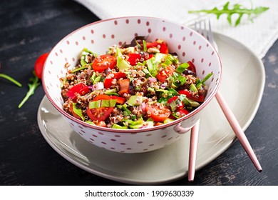 Tabbouleh with quinoa. Tabbouleh salad - traditional Middle Eastern or Arabic cuisine. Vegetarian salad with quinoa, tomato, avocado, green herbs and lemon juice. Vegan and vegetarian meal