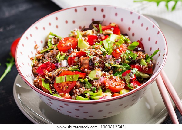 Tabbouleh with\
quinoa. Tabbouleh salad - traditional Middle Eastern or Arabic\
cuisine. Vegetarian salad with quinoa, tomato, avocado, green herbs\
and lemon juice. Vegan and vegetarian\
meal