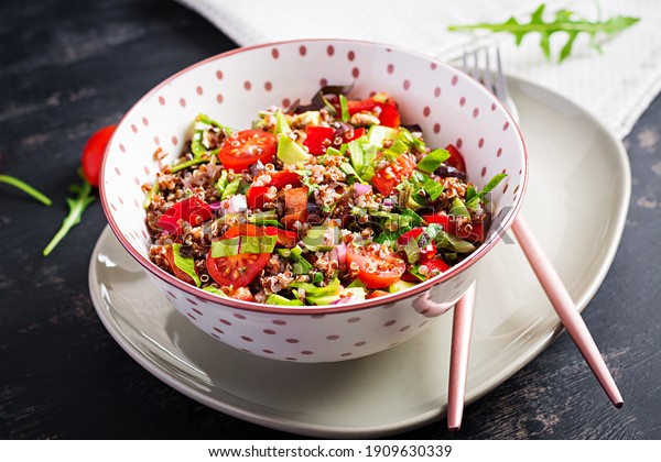 Tabbouleh with\
quinoa. Tabbouleh salad - traditional Middle Eastern or Arabic\
cuisine. Vegetarian salad with quinoa, tomato, avocado, green herbs\
and lemon juice. Vegan and vegetarian\
meal