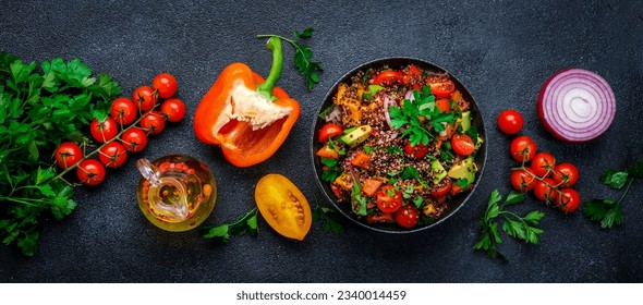 Tabbouleh salad with quinoa and cherry  tomatoes, red paprika, avocado, cucumbers, onion, parsley. Middle Eastern and Arabic dish. Black table background, top view - Powered by Shutterstock