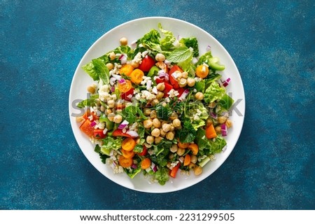 Tabbouleh salad. Tabouli salad with fresh parsley, onions, tomatoes, bulgur and chickpea. Healthy vegetarian food, diet. Top view